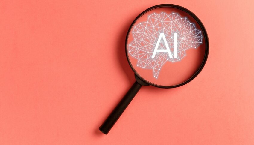 A magnifying glass against a peach background highlights "AI"