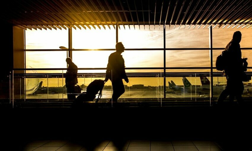 people walking through an airport